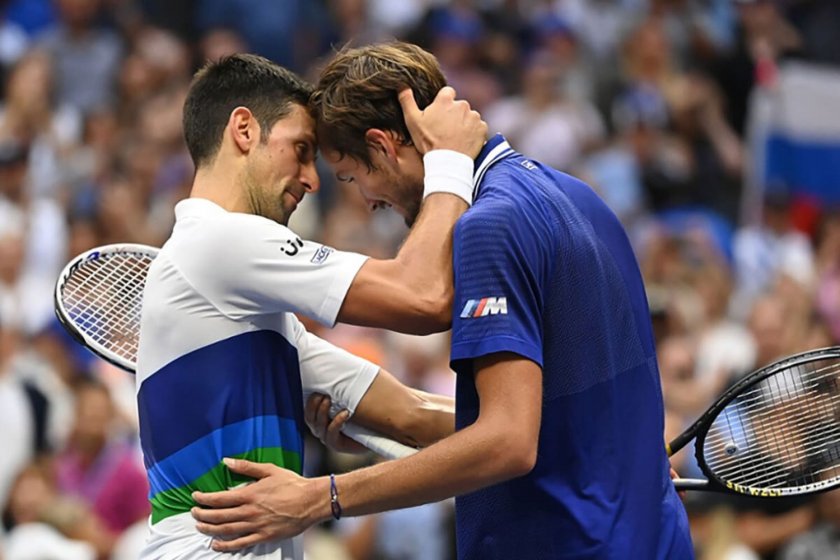 Novak Djokovic hugs Daniil Medvedev, courtesy of US Open. Photo by Garrett Ellwood USTA